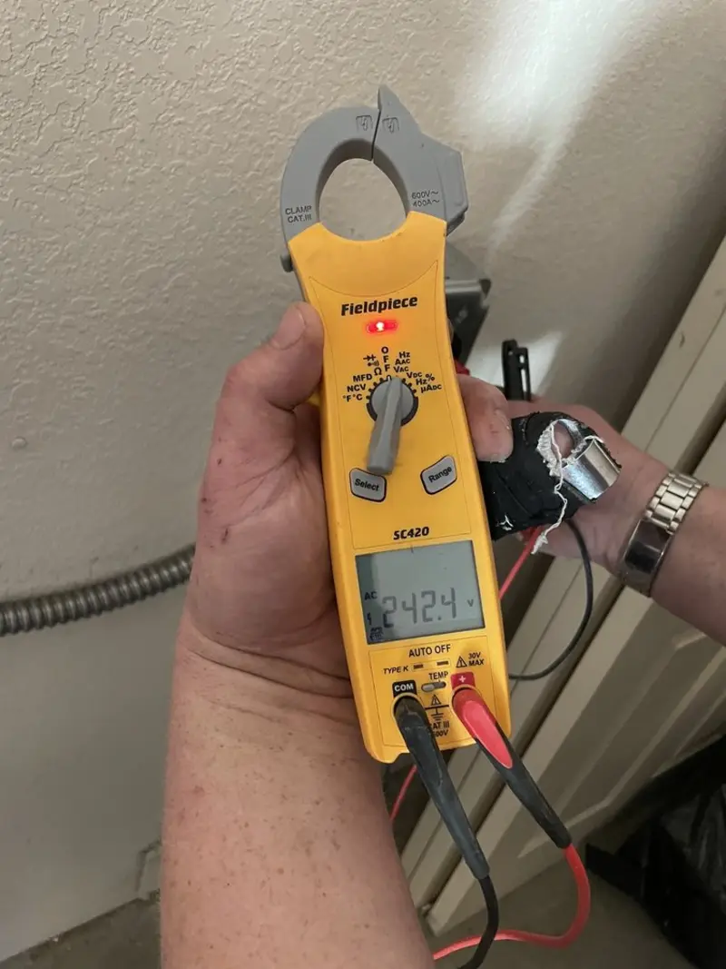 Voltage testing with clamp meter during Recessed Lighting Installation in Claryville
